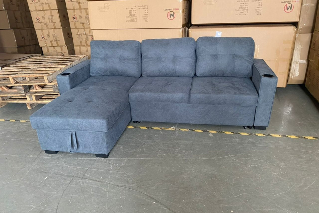 Full view of the Balsam Grey Fabric Reversible Sectional Sofa, showcasing the neutral color and the pull-out sleeper function extended.