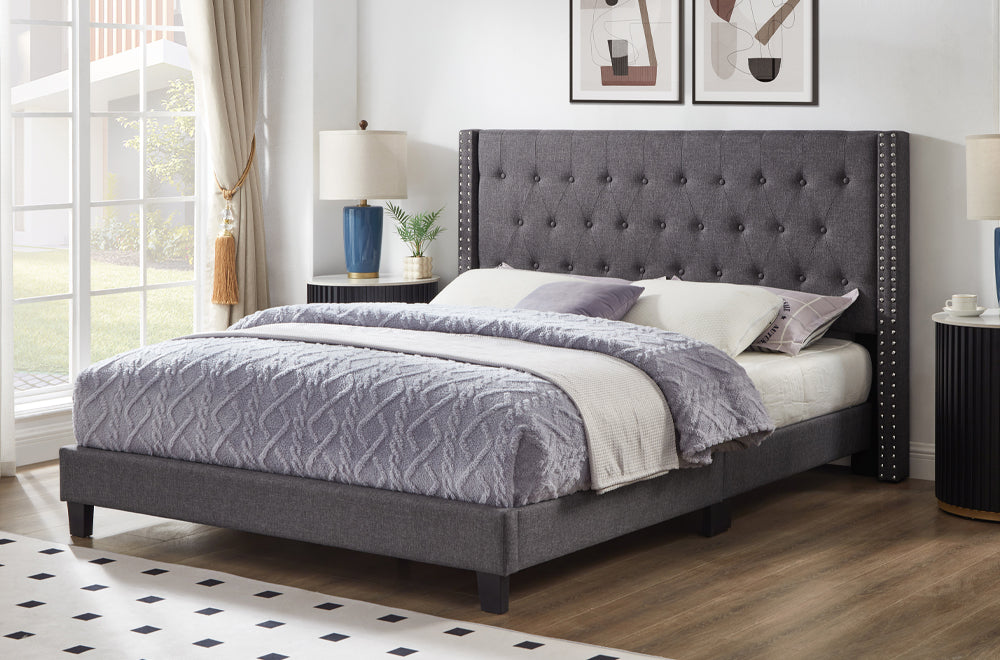 Modern upholstered platform bed with nailhead trim and button tufting in grey linen fabric