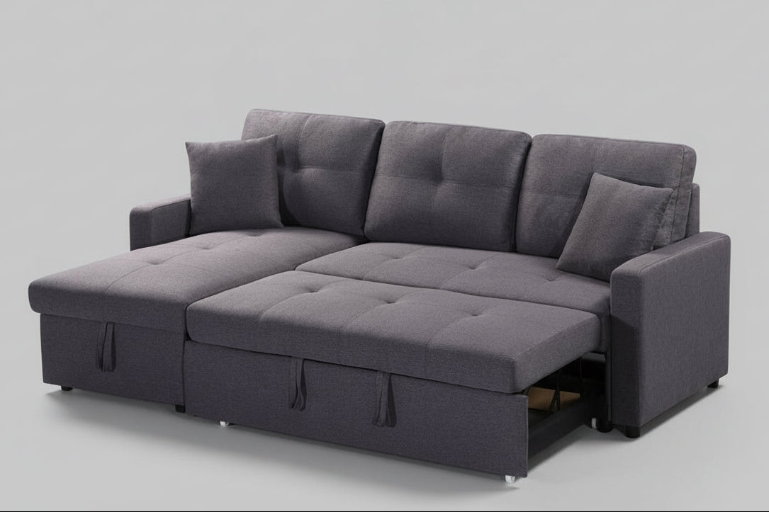 Full view of the Grey Reversible Sectional Sofa, showcasing the storage chaise and the pull-out sleeper function ready for use.