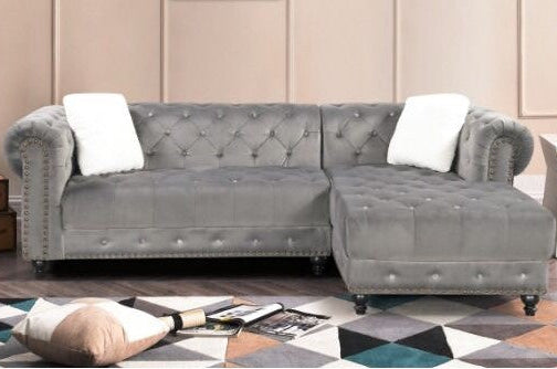 Full view of the Grey Velvet Reversible Sectional Sofa, showcasing the plush fabric, L-shape design, and the elegant diamond tufting on the back cushions.