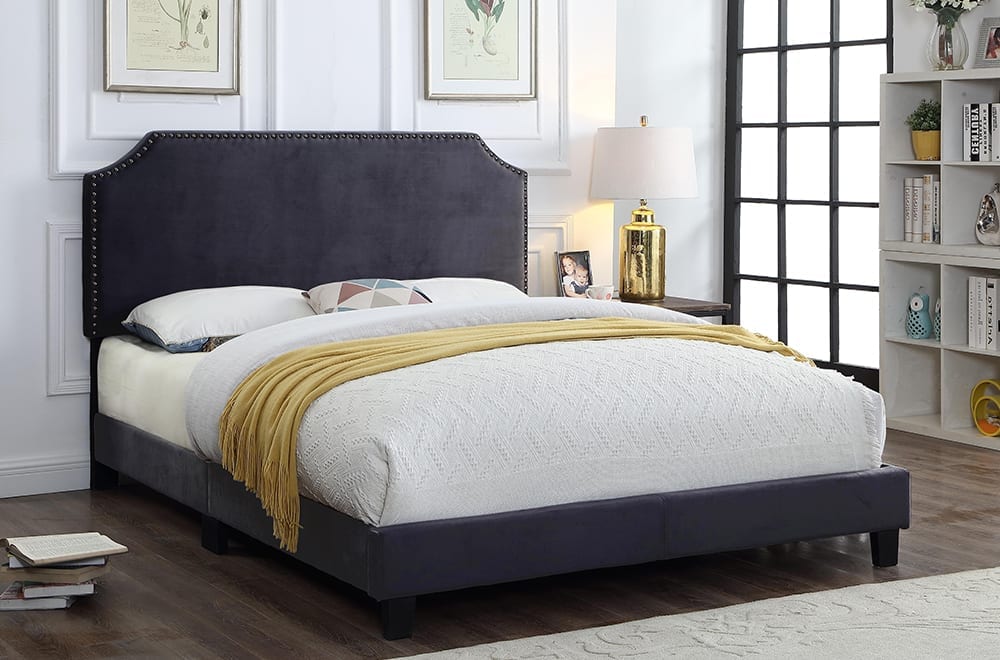 Elegant velvet bed with adjustable scallop-edge headboard and decorative nail-head detailing