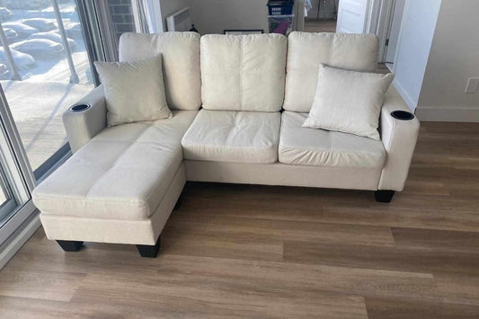 Full view of the 73 Inch Reversible Linen Sectional Sofa, showing the compact L-shape configuration with the ottoman chaise and center backrest cupholders.