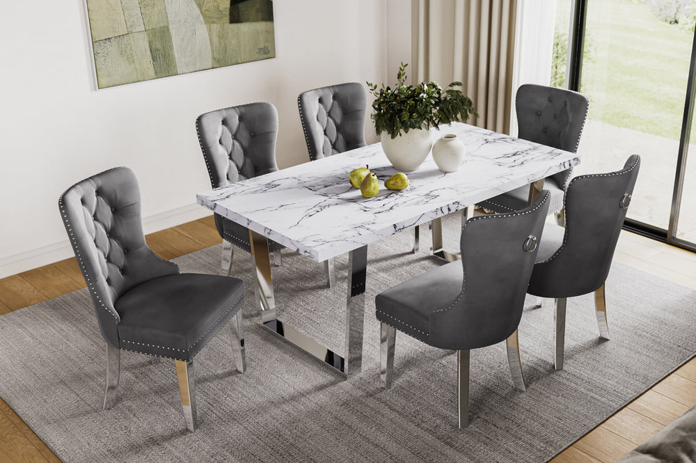 Full view of the 7-Piece Concrete-Look Faux Marble Dining Set, showcasing the industrial grey table top and six comfortable velvet upholstered chairs.
