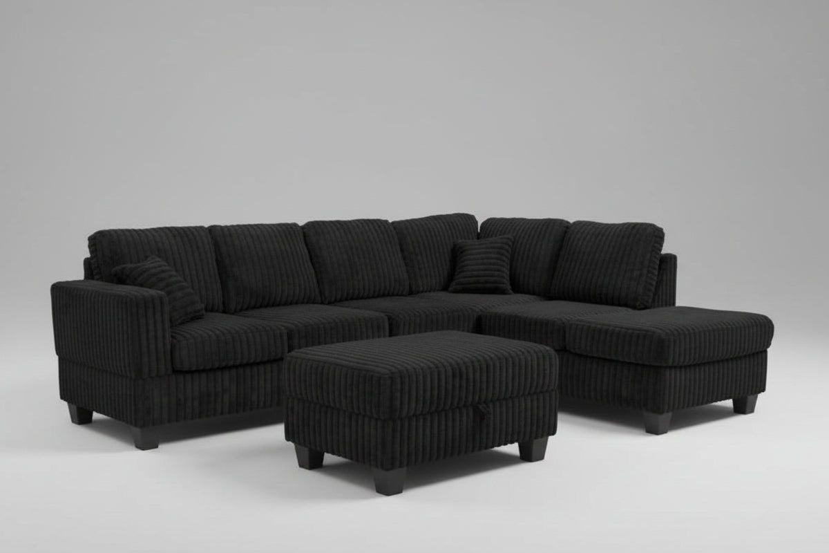 Full view of the Black Corduroy Reversible Sectional Sofa, showcasing the ribbed fabric and the versatile matching storage ottoman placed next to the chaise.