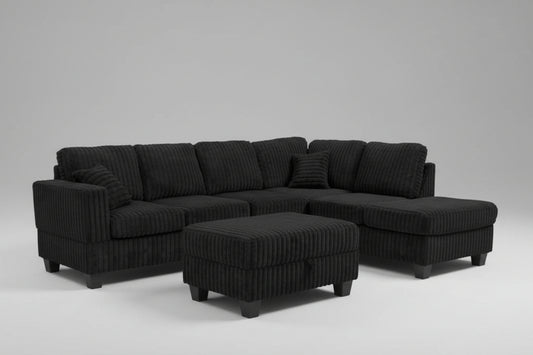 Full view of the Black Corduroy Reversible Sectional Sofa, showcasing the ribbed fabric and the versatile matching storage ottoman placed next to the chaise.
