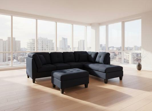 Full view of the Black Fabric Reversible Sectional Sofa, showcasing the L-shape configuration and the matching storage ottoman placed at the end.
