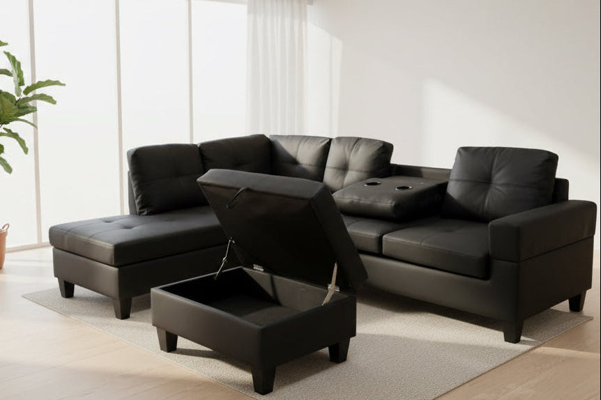 Full view of the Black Leather Reversible Sectional Sofa, showcasing the sleek upholstery, storage ottoman, and the center console with cup holders.