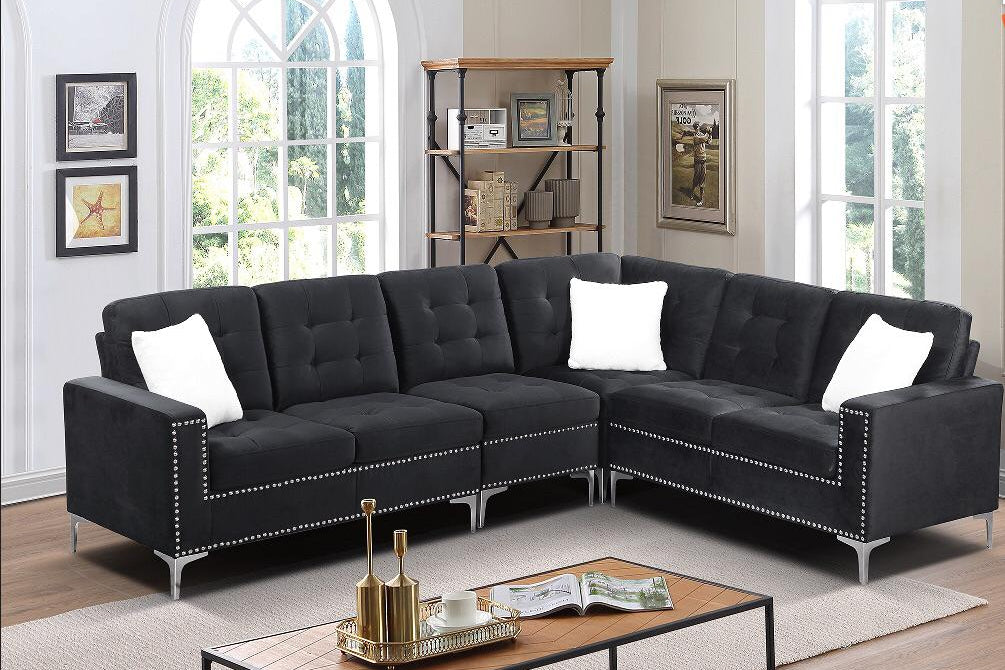 Full view of the Black Velvet Fabric Sectional Sofa, showcasing the rich, plush upholstery, three included accent pillows, and the sleek chrome legs.