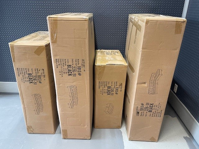 Close-up detail of the Black Velvet storage ottoman lid lifted, clearly revealing the large internal storage capacity for blankets or accessories.