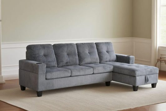 Full view of the 4-Seater Corduroy Sectional Sofa, showcasing the unique ribbed fabric and the console with cup holders, along with the reversible chaise.