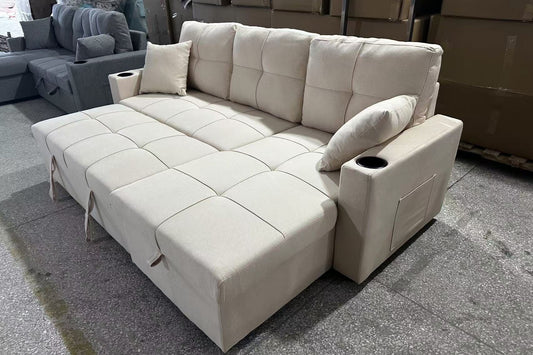 Full view of the Courtney Beige Fabric Reversible Sectional Sofa, showcasing the neutral color and the pull-out sleeper function ready for use.
