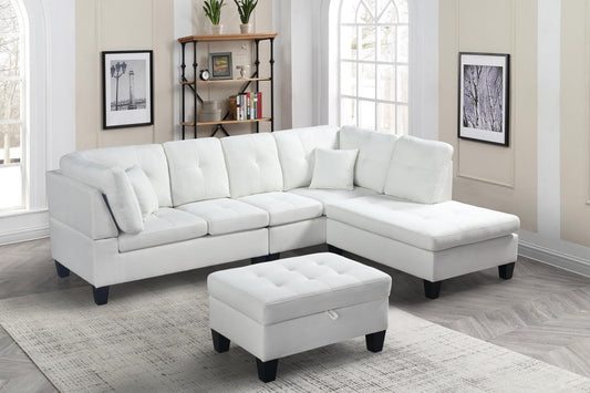 Full view of the Cream Fabric Reversible Sectional Sofa, showcasing the bright upholstery and the matching storage ottoman placed beside the chaise.