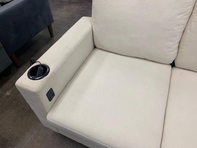 Close-up view of the center console, clearly highlighting the integrated USB charging ports and the dual cupholders on the Cream Fabric.