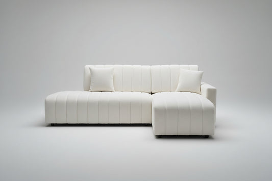 Full view of the Creamy White Fabric 3-Piece Sectional Sofa with a right-hand chaise, arranged in a bright, airy room.
