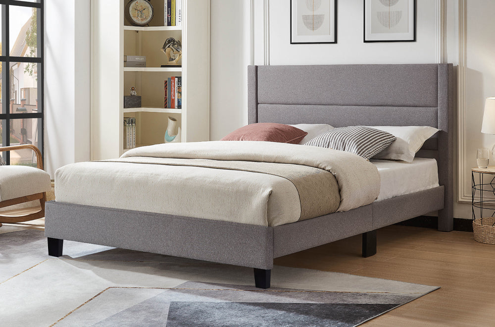Modern upholstered platform bed with elegant channel tufting and soft fabric upholstery
