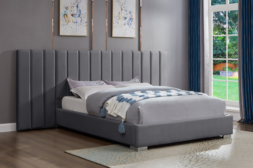 Modern velvet upholstered bed with extended headboard and sturdy slatted base
