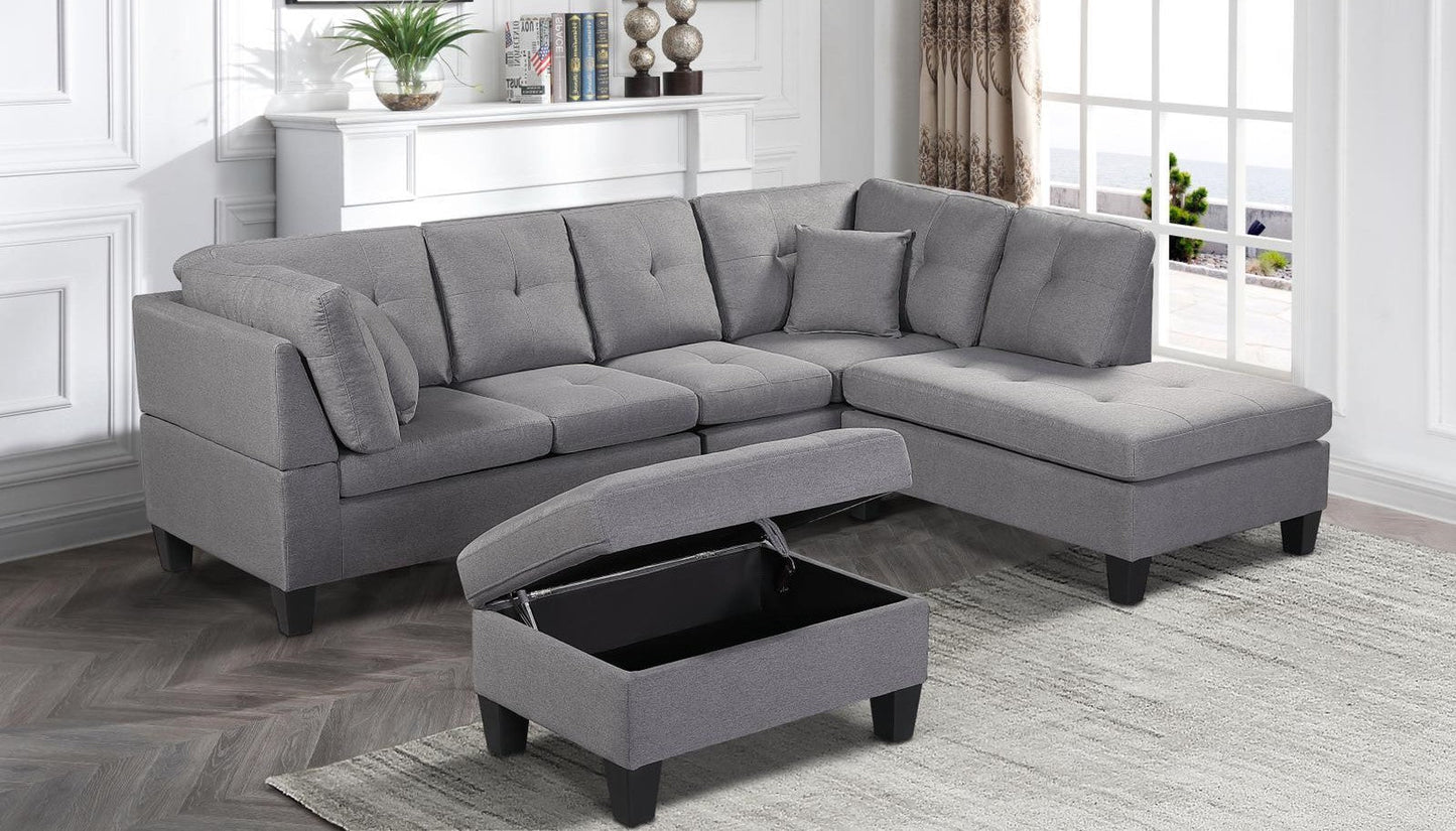 Full view of the Fabric Reversible Sectional Sofa, showing the included accent pillows and the matching storage ottoman placed next to the chaise.
