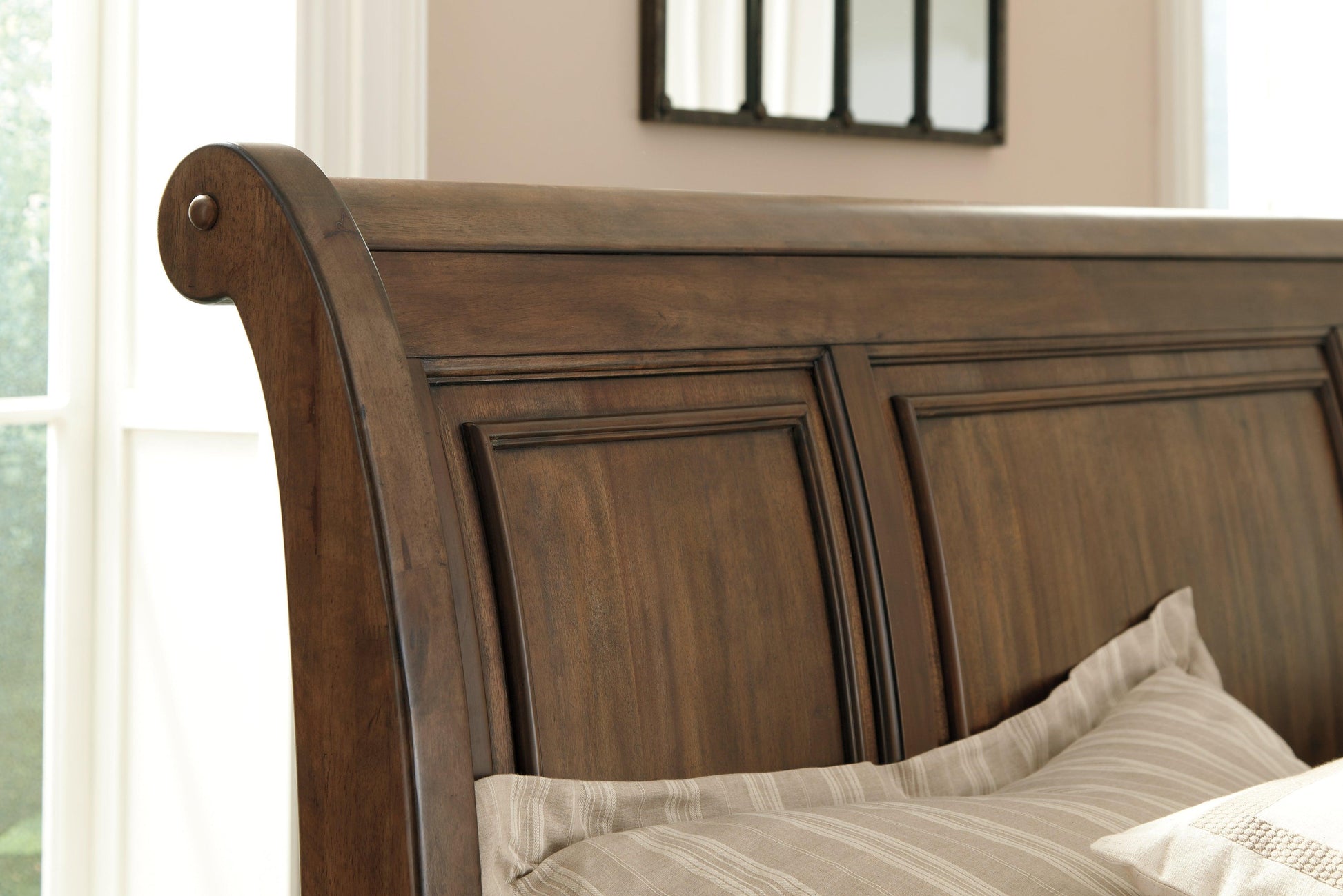 Close-up of the Flynnter bed footboard, showing the two storage drawers and the medium brown wood finish.