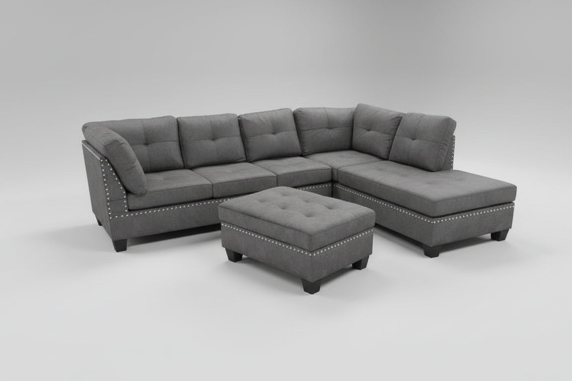 Full view of the Grey Fabric Reversible Sectional Sofa, showing the included accent pillows and the matching storage ottoman placed next to the chaise.
