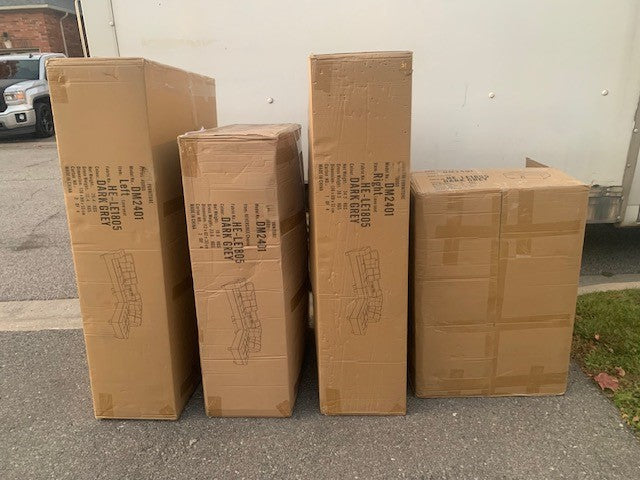 Close-up detail of the durable Grey Fabric, highlighting the console with dual cup holders and the storage ottoman with its lid open for maximum capacity.