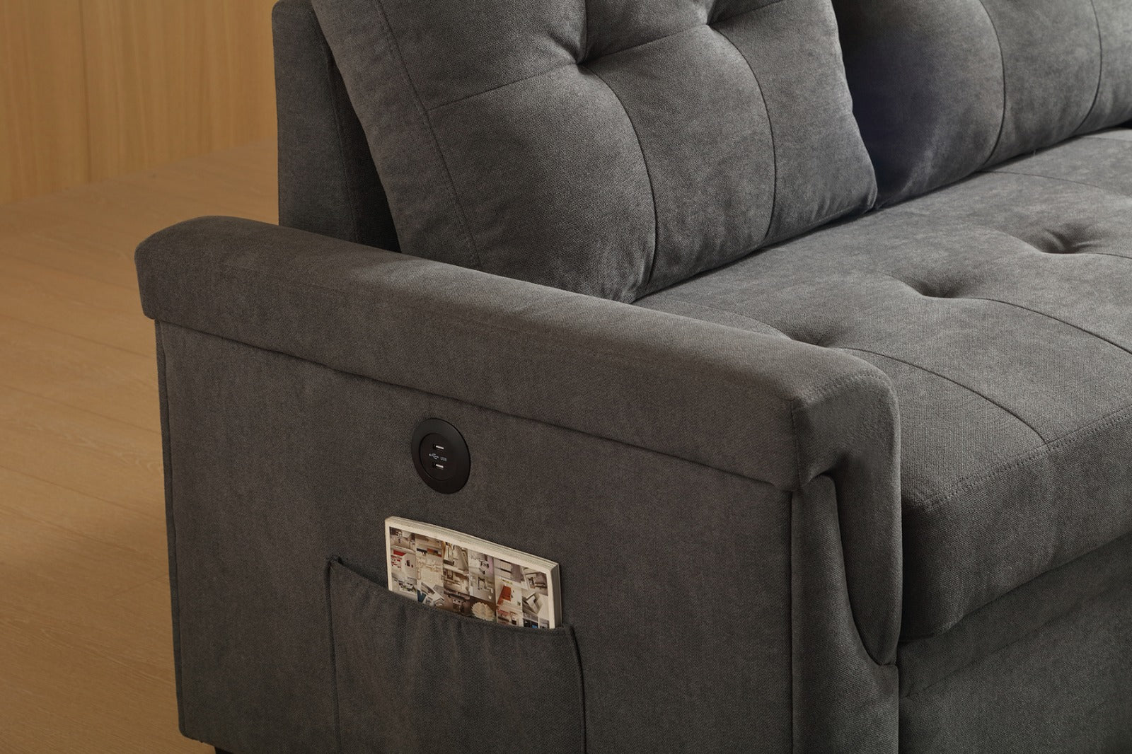 Angled view emphasizing the compact design and the functional combination of the reversible chaise and the pull-out sleeper bed.