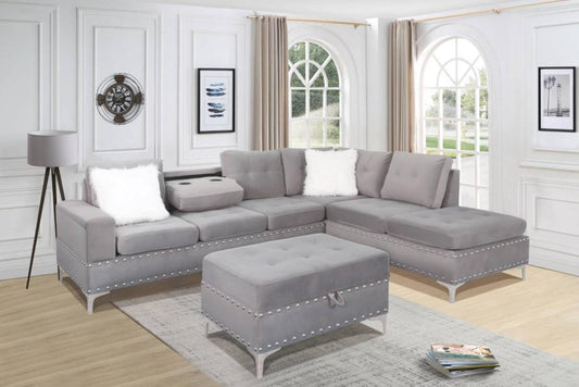 Full view of the Ivy Grey Velvet Reversible Sectional Sofa, showcasing the plush fabric and the versatile matching storage ottoman placed next to the chaise.