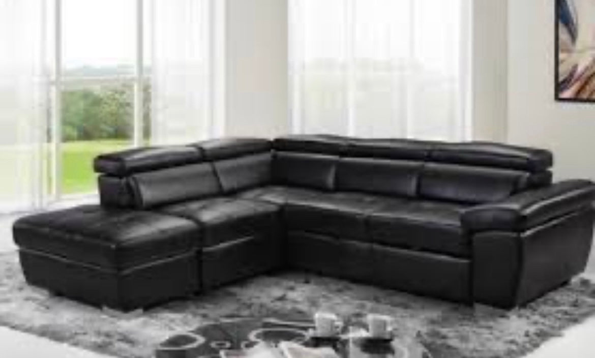 Angled view of the Lauren 100-inch Leather-Gel Sectional Sofa with the bed fully pulled out, demonstrating the sleek look and sleeper surface.