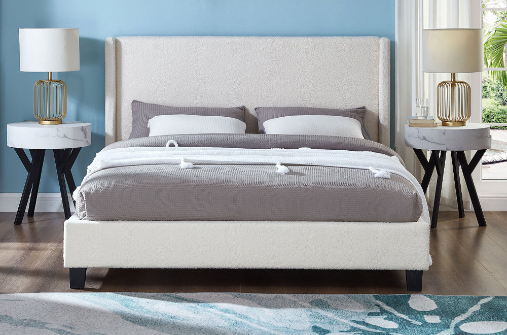 Elegant boucle upholstered bed with modern winged headboard and cozy minimalist style
