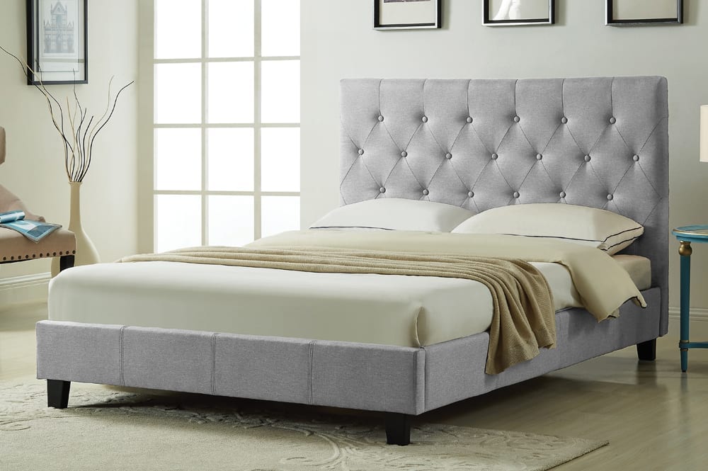 Contemporary upholstered bed featuring button-tufted headboard and solid wood slat base
