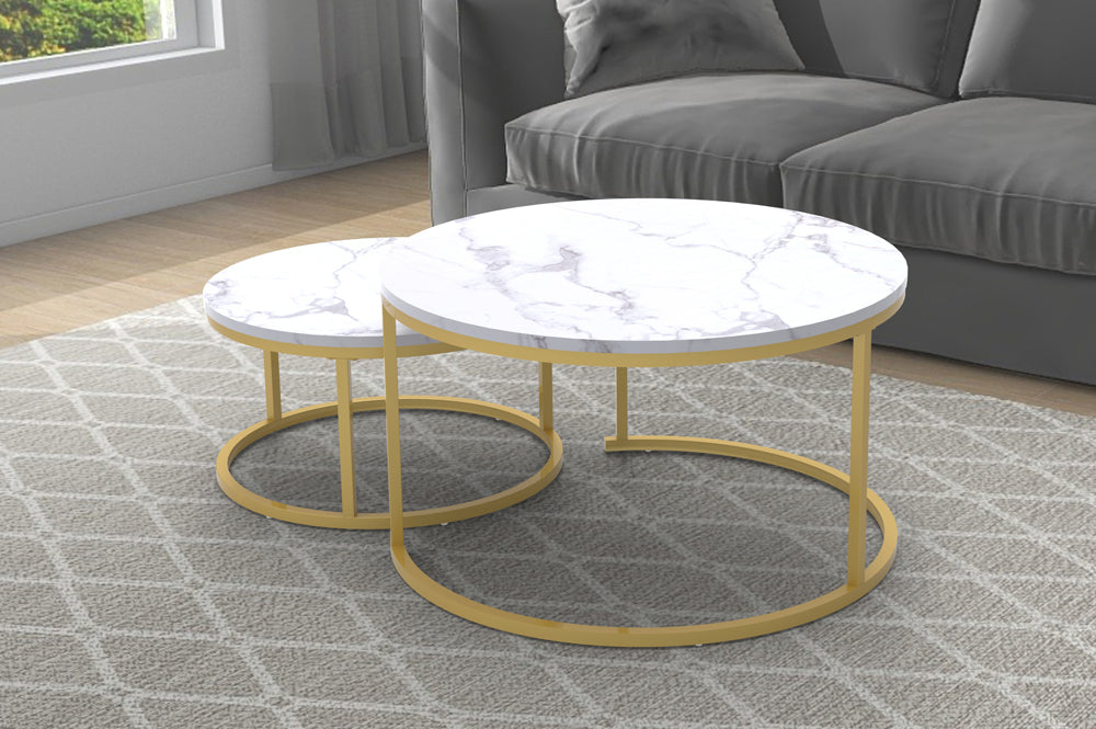 Close-up detail of one table's White Marble top, focusing on the veining and the seamless, elegant connection point to the Brushed Gold metal frame.