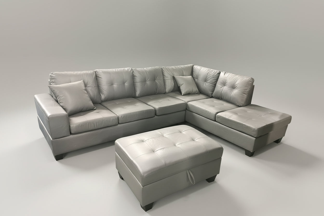 Full view of the Roma Grey Faux Leather Reversible Sectional Sofa, showcasing the sleek upholstery and the versatile matching ottoman placed next to the chaise.