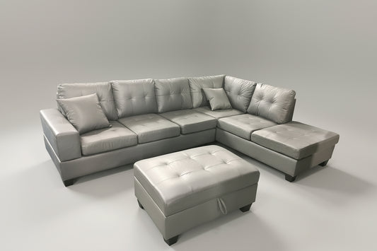 Full view of the Roma Grey Faux Leather Reversible Sectional Sofa, showcasing the sleek upholstery and the versatile matching ottoman placed next to the chaise.