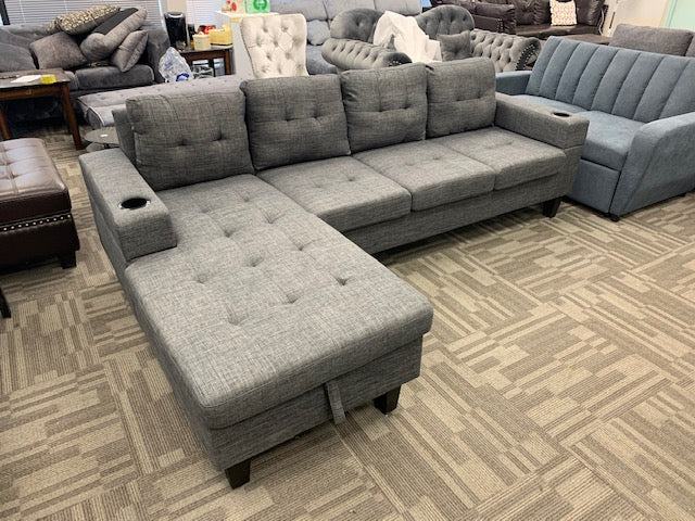 Detailed view of the fixed Left-Facing Chaise cushion lifted, clearly showing the full capacity of the internal storage compartment.