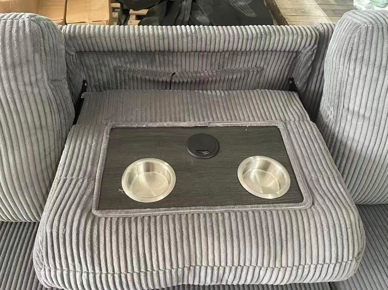 Angled view illustrating the smooth pull-out bed mechanism of the Shelf Grey sectional, emphasizing the easy conversion to a bed.