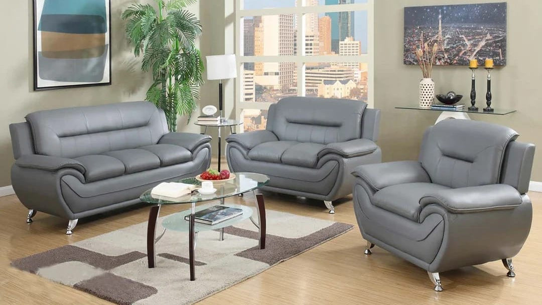 Full view of the Speedy Grey Faux Leather Tufted 3-Piece Set, showcasing the matching sofa, loveseat, and chair with tufting visible on the backrests.